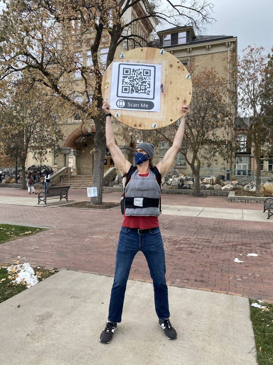 Daniel Porter wearing body weights and holding a QR Code