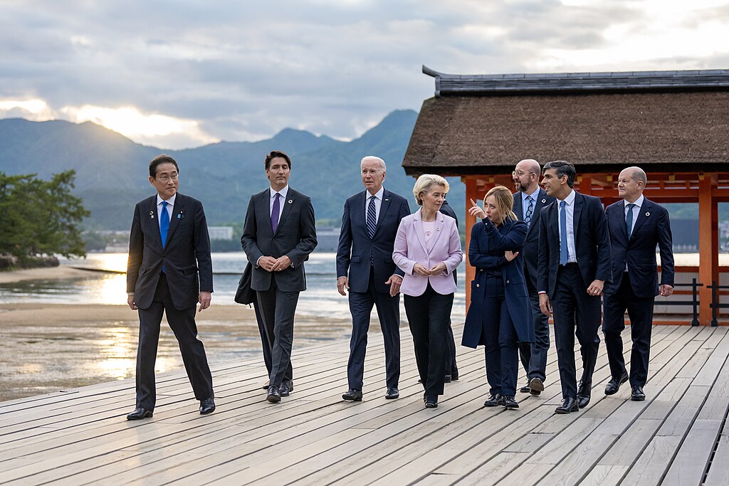 G7 leaders walking in front of a Japanese shrine during the G7 summit in 2023 in Japan during sunset.