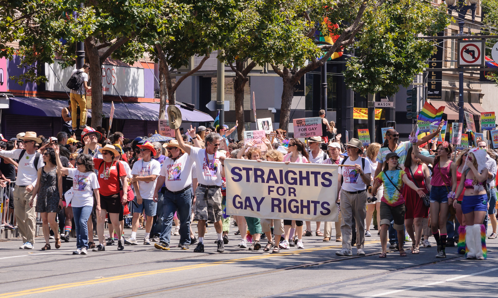 Heterosexual supporters of gay rights marching in San Francisco Pride with a banner.