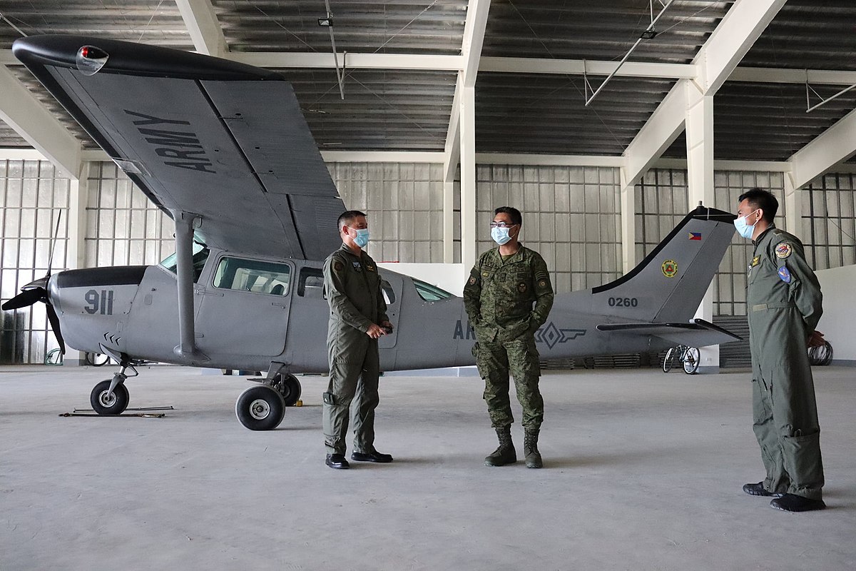 A group of soldiers in the Philippine Army stand next to a Cessna aircraft, 2021.