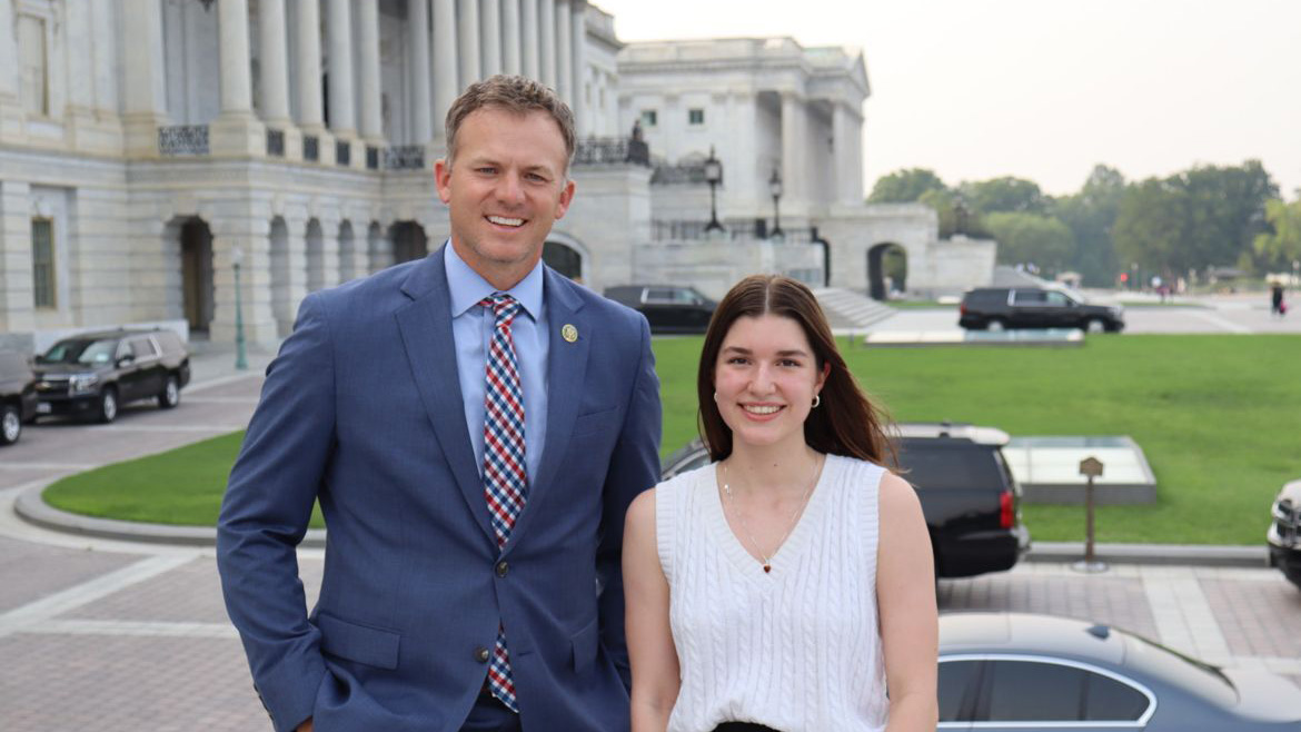 Journalism student Hailey Brown stands with politician