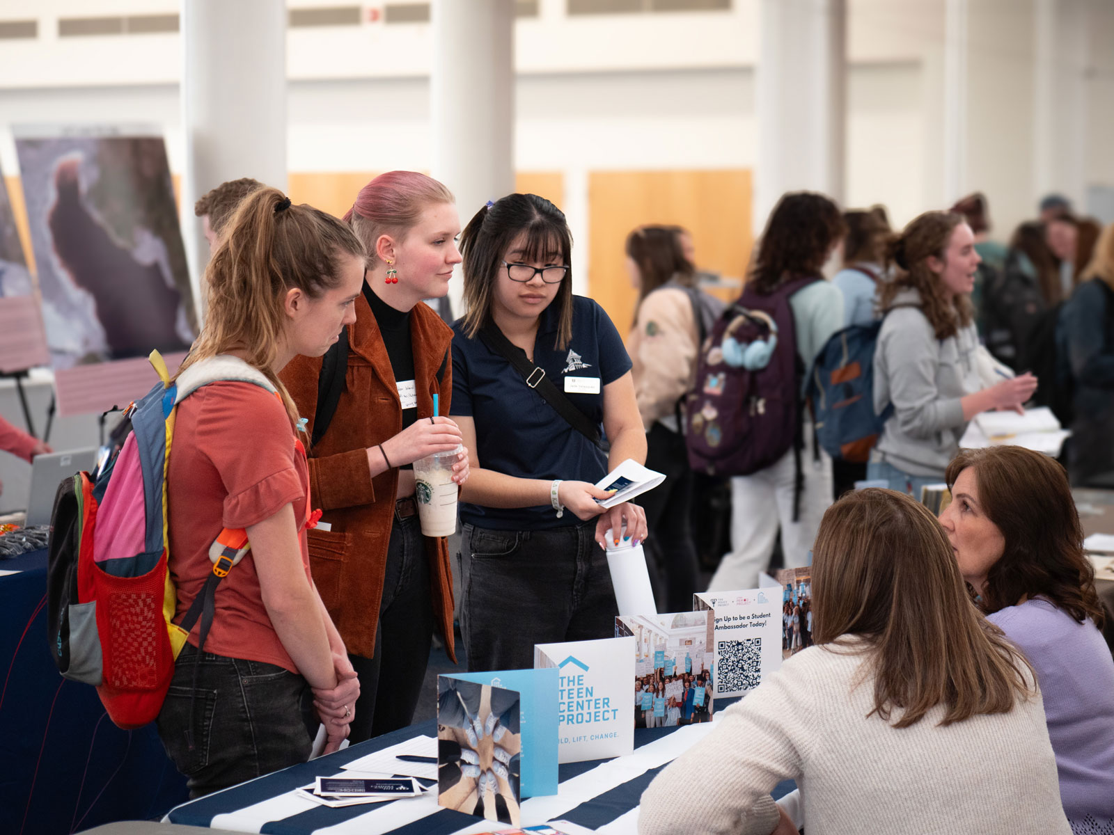 Students talk to representatives from the Policy Project at USU's Nonprofit Career Fair on March 21, 2024