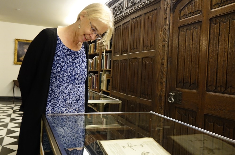 Prof. Phebe Jensen looks at books that are part of a new exhibit on Shakespeare.