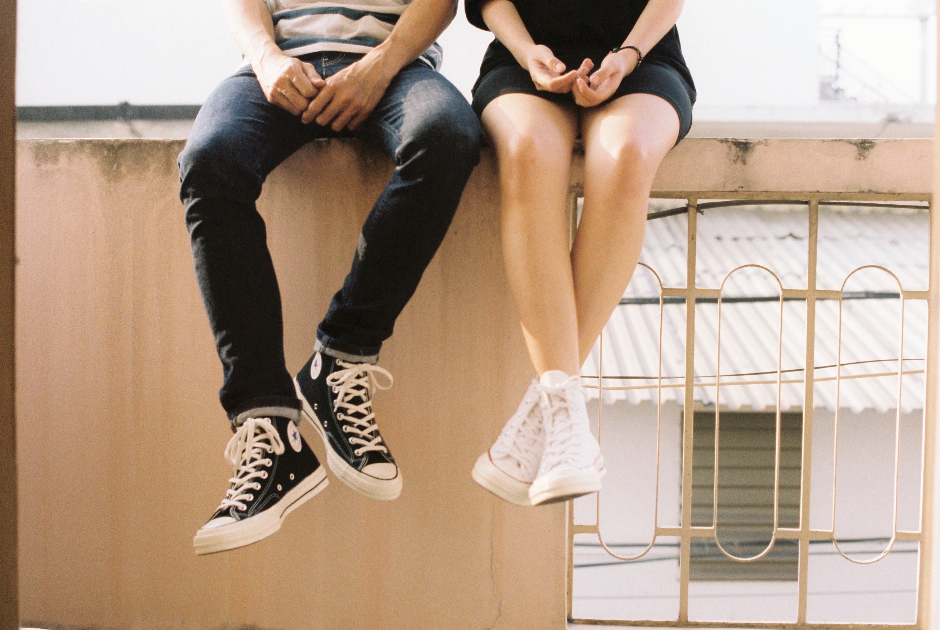 Couple sitting on a wall talking