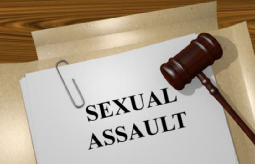 A gavel laying on top of a file that reads "Sexual Assault"